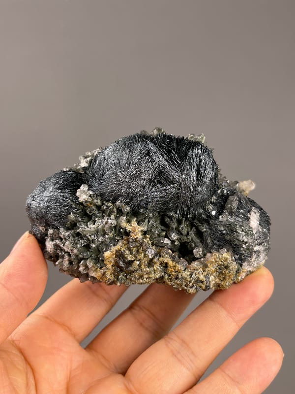 Hematite from Inner Mongolia, China: curved metallic blades on granular matrix.