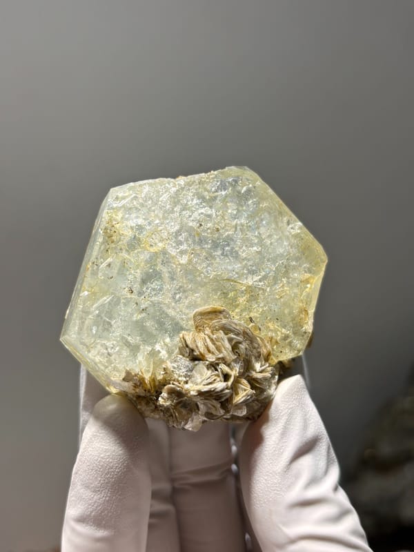 Hexagonal aquamarine plate with mica rosette from Xuebaoding, Sichuan, China, close-up of the crystal faces
