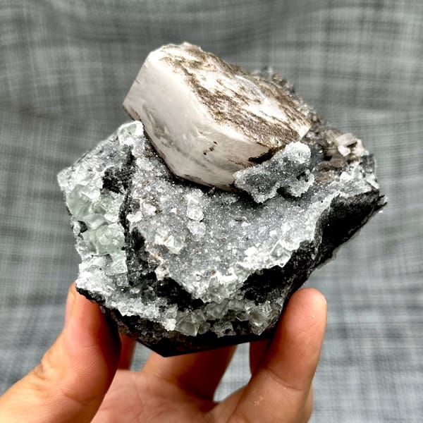 Hexagonal calcite with fluorite and quartz, from Fujian, China, front view in daylight, view 4 of 12
