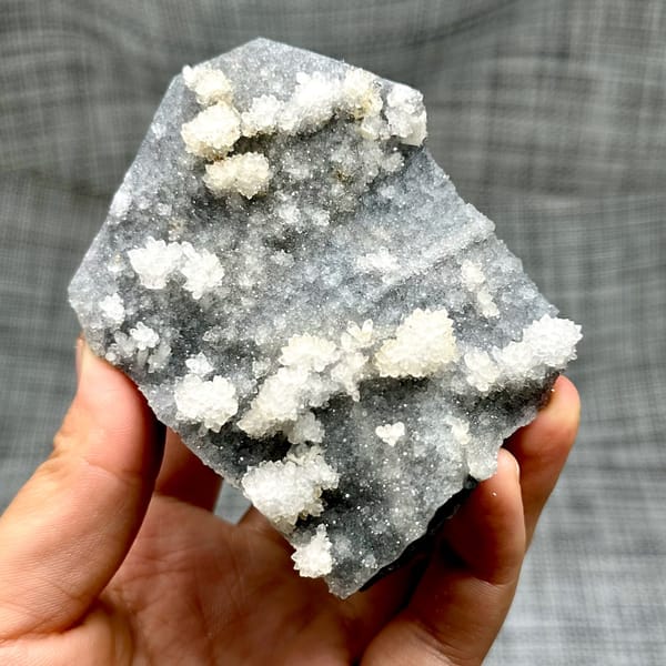 Hexagonal calcite with fluorite and quartz, from Fujian, China, front view in daylight, view 5 of 12