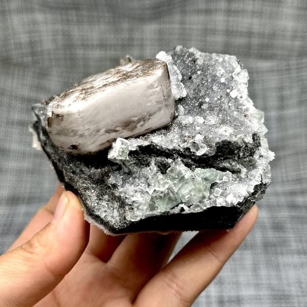 Hexagonal calcite with fluorite and quartz, from Fujian, China, front view in daylight, view 8 of 12