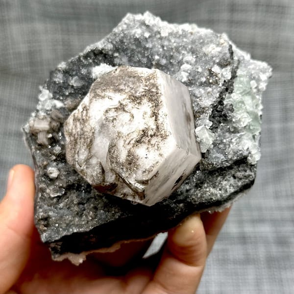 Hexagonal calcite with fluorite and quartz, from Fujian, China, front view in daylight, view 11 of 12