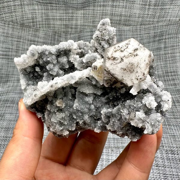 Hexagonal calcite plate on quartz, from Fujian, China, front view in daylight