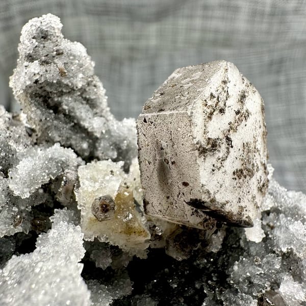 Hexagonal calcite plate on quartz, from Fujian, China, front view in daylight, view 4 of 11
