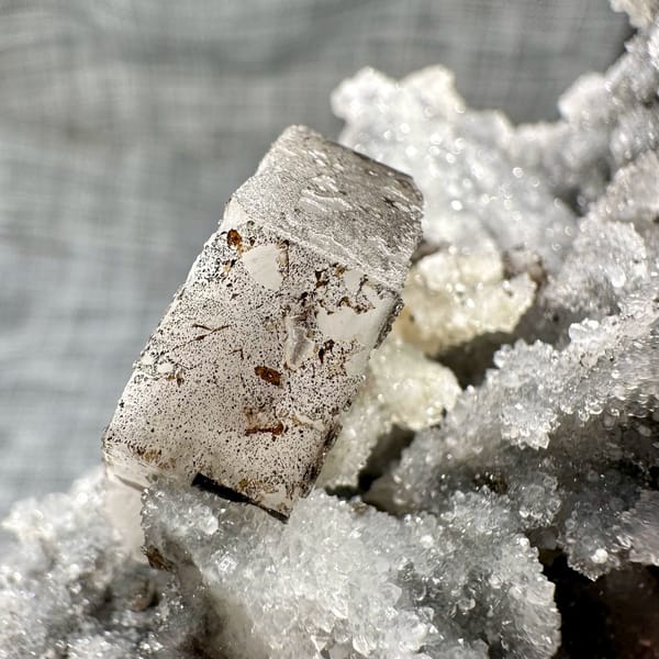Hexagonal calcite plate on quartz, from Fujian, China, front view in daylight, view 5 of 11