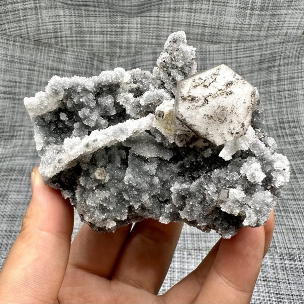 Hexagonal calcite plate on quartz, from Fujian, China, front view in daylight, view 7 of 11