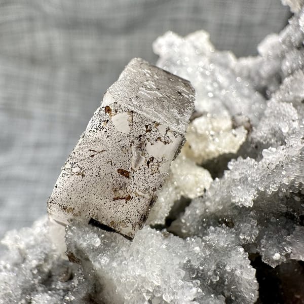 Hexagonal calcite plate on quartz, from Fujian, China, front view in daylight, view 10 of 11