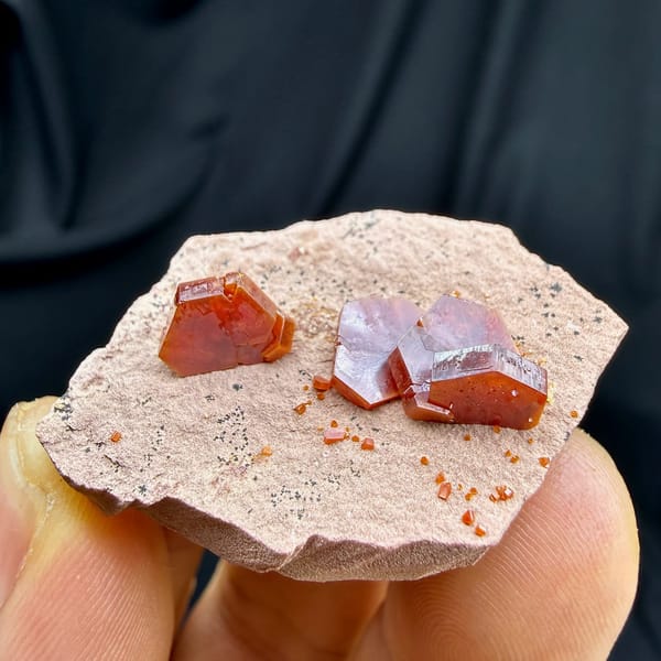 Ruby-red hexagonal vanadinite crystals on pale sandstone from Morocco, view 3 of 6