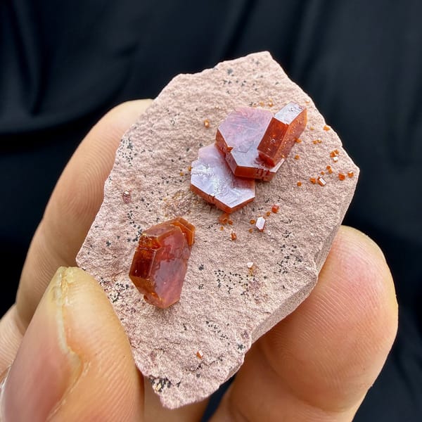 Ruby-red hexagonal vanadinite crystals on pale sandstone from Morocco, view 4 of 6