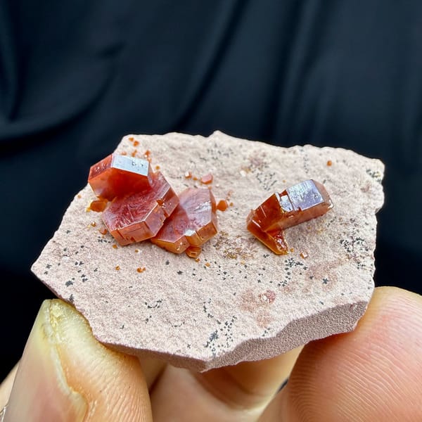 Ruby-red hexagonal vanadinite crystals on pale sandstone from Morocco, view 5 of 6