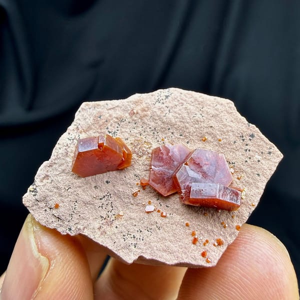 Ruby-red hexagonal vanadinite crystals on pale sandstone from Morocco, view 6 of 6