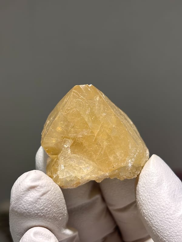 Honey-orange scheelite crystal from Xuebaoding, Sichuan, China, close-up of the crystal faces, third view