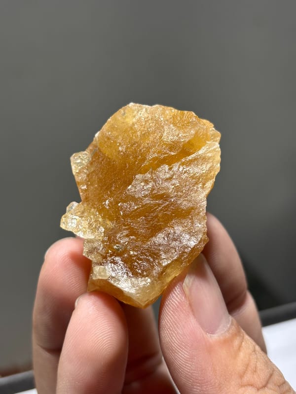 Honey-orange scheelite crystal from Xuebaoding, Sichuan, China, close-up of the crystal faces