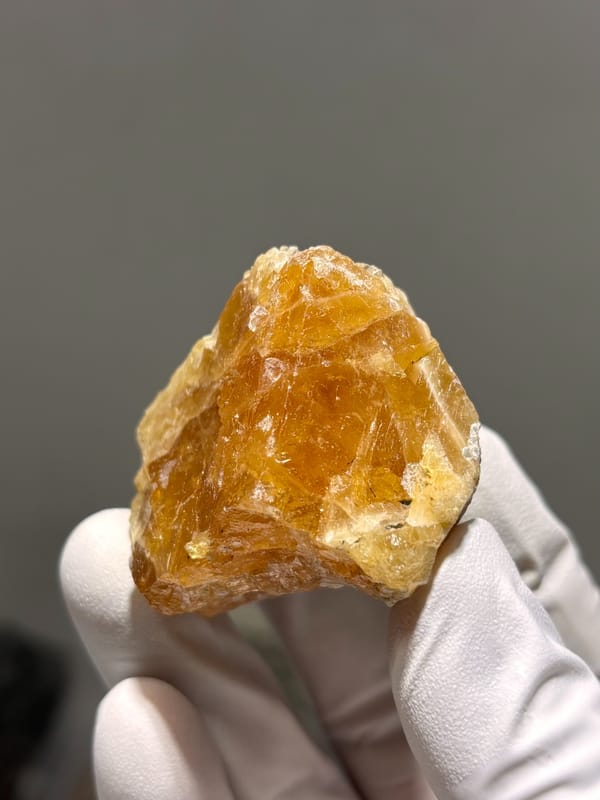 Large honey-orange scheelite crystal from Xuebaoding, Sichuan, China, close-up of the crystal faces