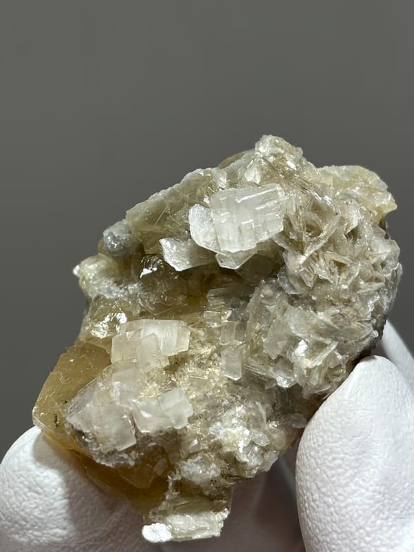 Honey scheelite with white calcite and mica from Xuebaoding, Sichuan, China, reverse side