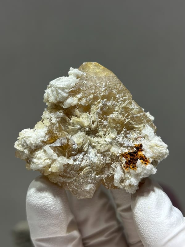 Large honey scheelite with white calcite from Xuebaoding, Sichuan, China, top view