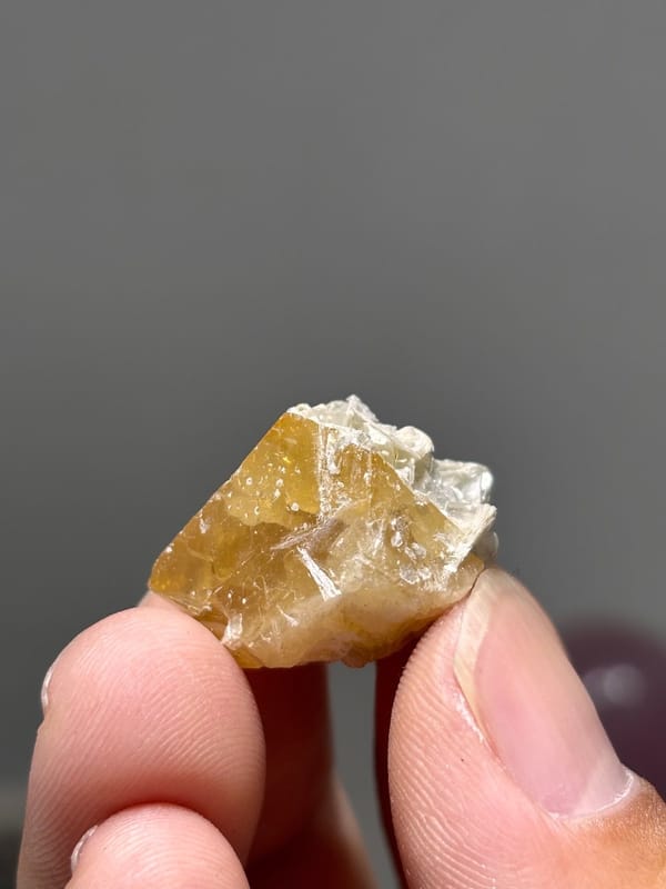 Small honey scheelite crystal with mica from Xuebaoding, Sichuan, China