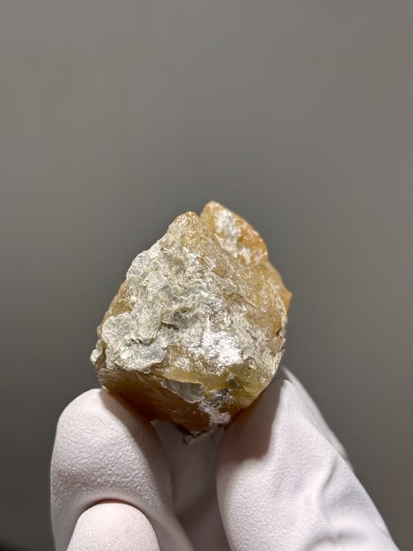 Honey scheelite group with white mica from Xuebaoding, Sichuan, China, second angle