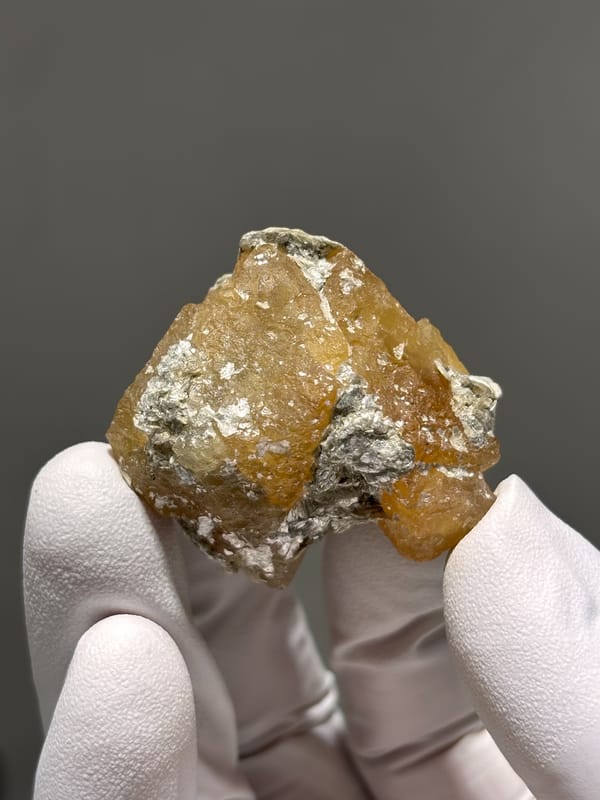 Honey scheelite group with white mica from Xuebaoding, Sichuan, China, reverse side
