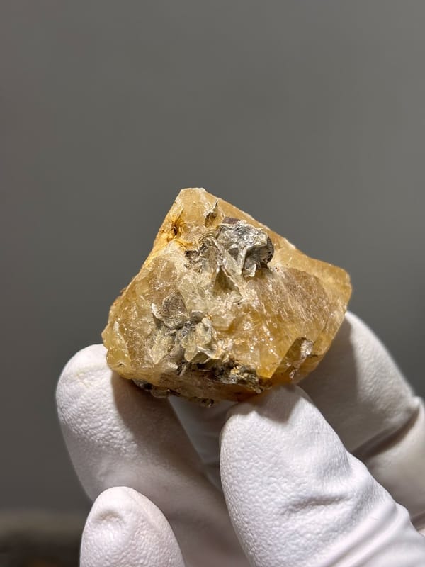 Honey scheelite with dark mica cap from Xuebaoding, Sichuan, China, view 4 of 5