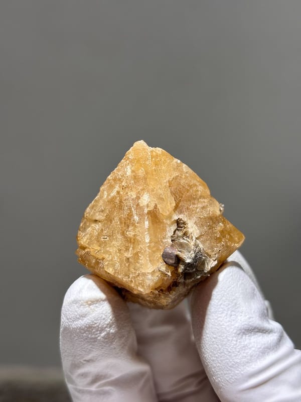 Honey scheelite with dark mica cap from Xuebaoding, Sichuan, China, view 5 of 5