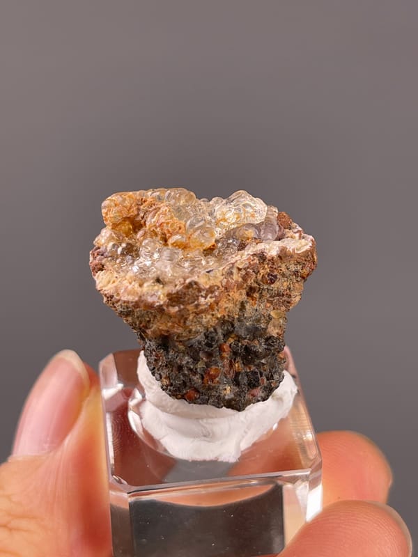 Hyalite Opal from Mexico: transparent rounded forms above a dark lower base.