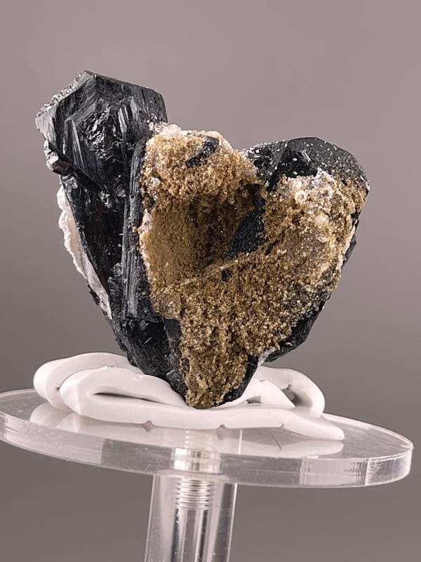 Ilvaite specimen from Inner Mongolia, China bearing black striated prismatic crystals