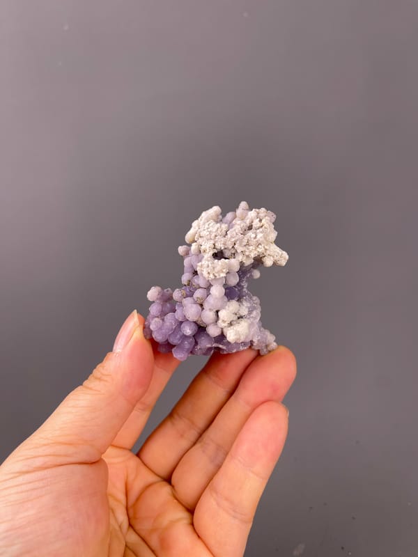 Lavender botryoidal chalcedony spheres on natural grape agate specimen from Indonesia