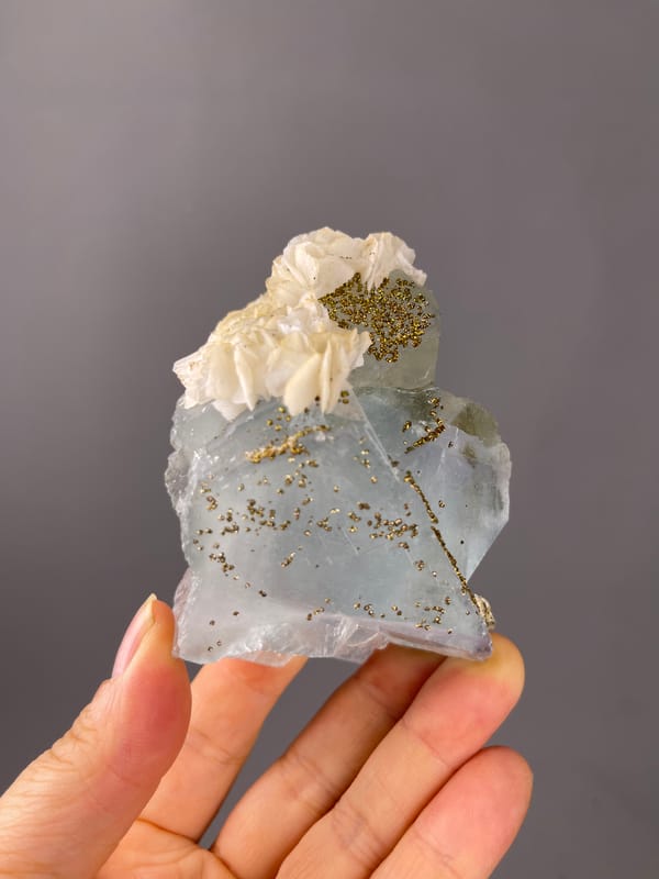 Light Blue Fluorite specimen from Yaogangxian Mine, Hunan, China showing pale blue cleavage faces with pyrite