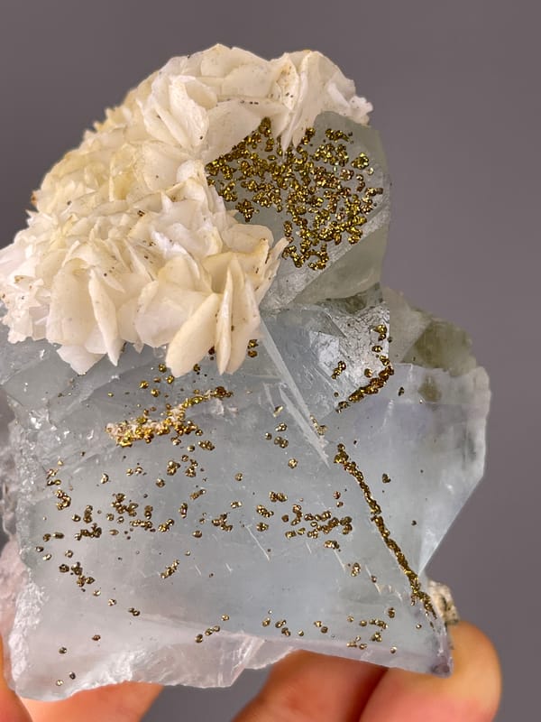 Light Blue Fluorite specimen from Yaogangxian Mine, Hunan, China displaying pale blue cleavage faces with pyrite