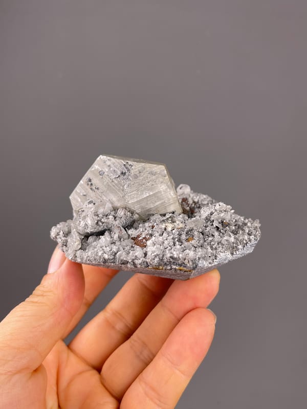 Mercedes-head Calcite specimen from Fujian, China featuring pale beige crystal on gray druse