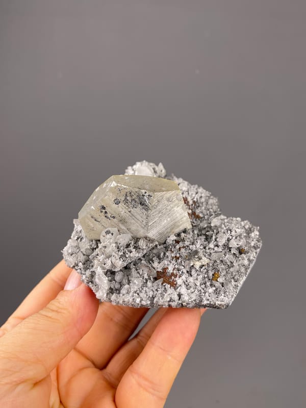 Mercedes-head Calcite specimen from Fujian, China presenting pale beige crystal on gray druse