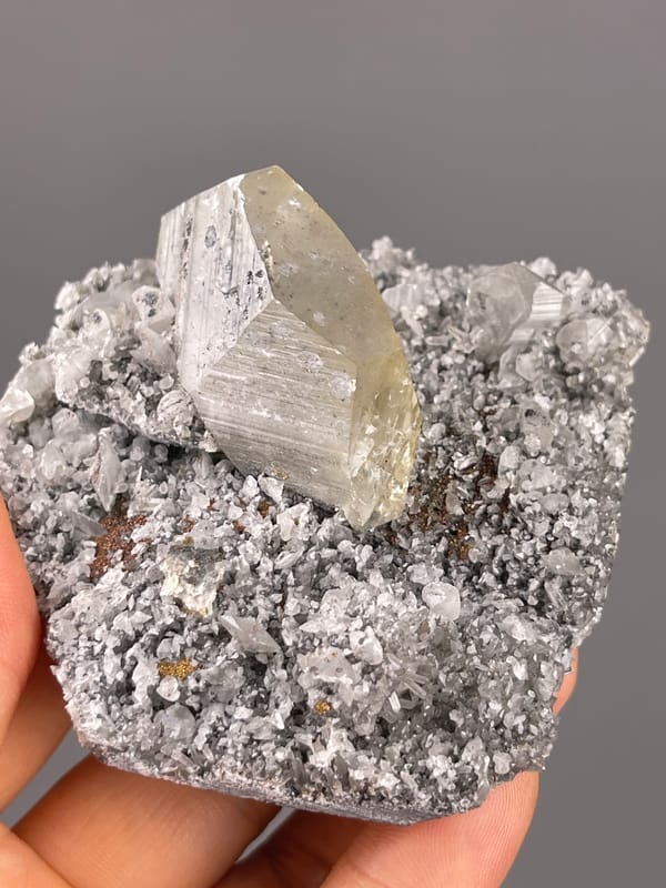 Pale beige crystal on gray druse on natural mercedes-head calcite specimen from Fujian, China
