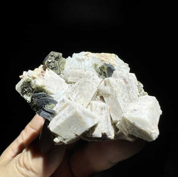 Blocky cream feldspar crystals with dark green mica from Yunxiao, Fujian, China, view 6 of 6