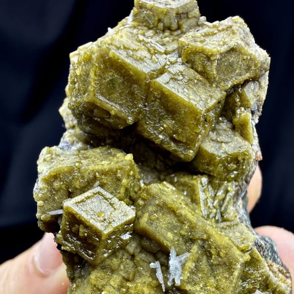 Olive-green grossular garnet dodecahedra with calcite from Inner Mongolia, China, view 3 of 6