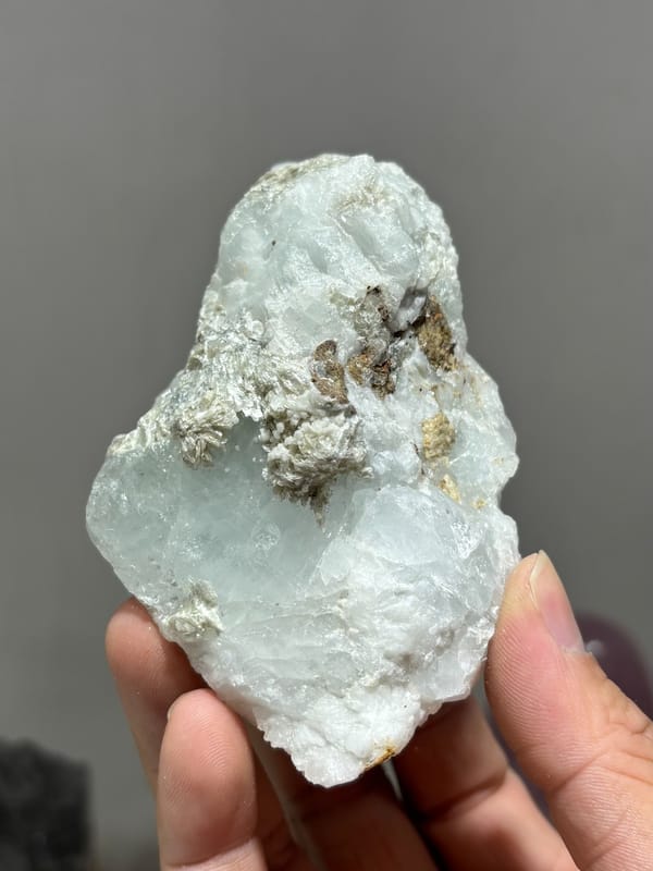 Opaque aquamarine single crystal from Xuebaoding, Sichuan, China, held in hand