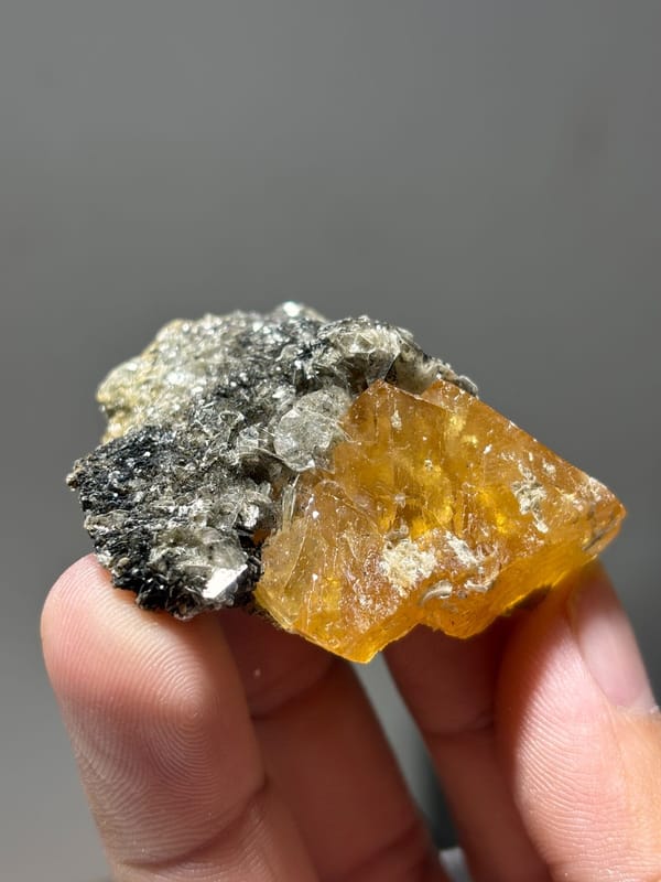 Orange scheelite floater with aquamarine and mica from Xuebaoding, Sichuan, China, second angle