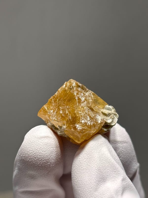 Orange scheelite crystal with mica flecks from Xuebaoding, Sichuan, China