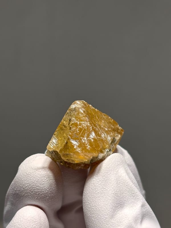 Orange scheelite crystal with mica flecks from Xuebaoding, Sichuan, China, view 3 of 6