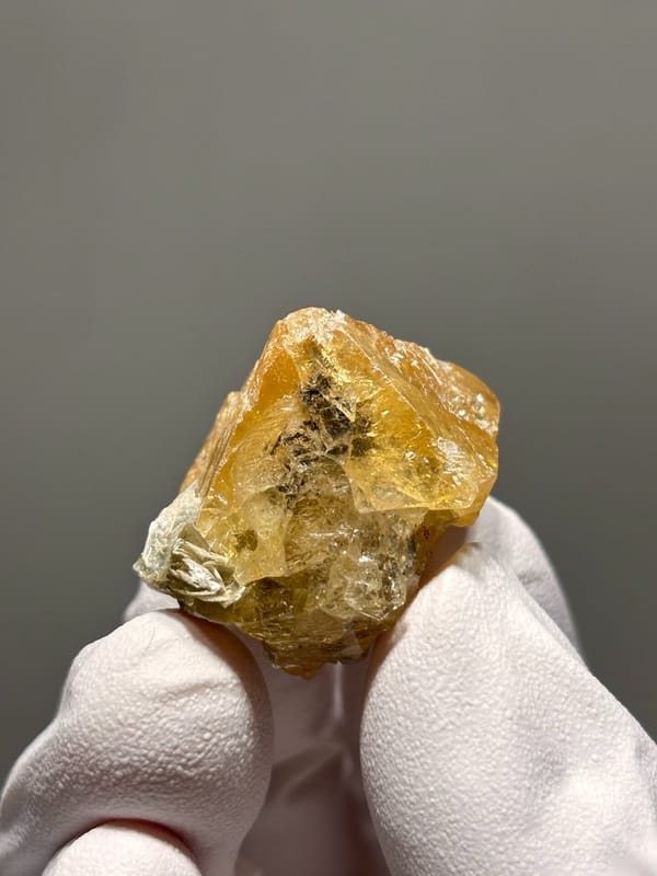 Orange scheelite crystal with mica flecks from Xuebaoding, Sichuan, China, view 4 of 6