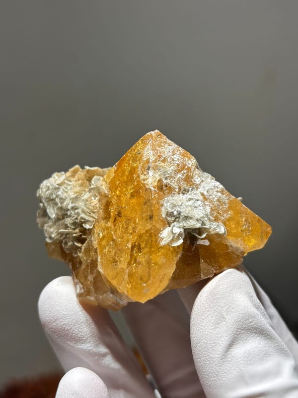 Orange scheelite with golden mica rosette from Xuebaoding, Sichuan, China, second angle