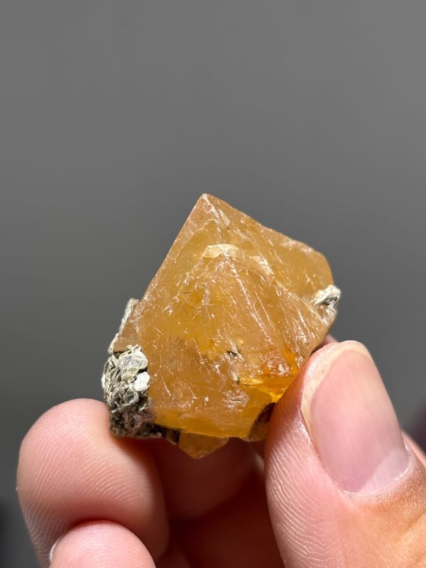 Orange scheelite floater crystal from Xuebaoding, Sichuan, China