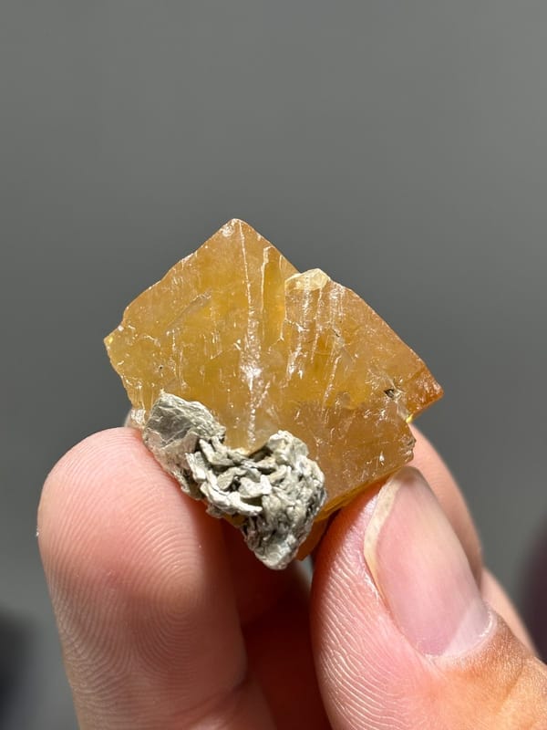 Orange scheelite floater crystal from Xuebaoding, Sichuan, China, view 2 of 5