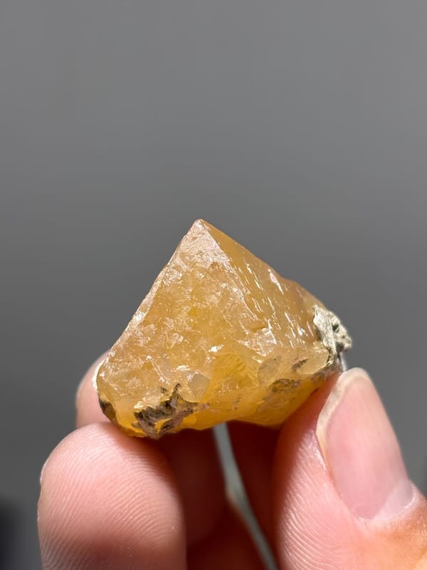 Orange scheelite floater crystal from Xuebaoding, Sichuan, China, view 3 of 5