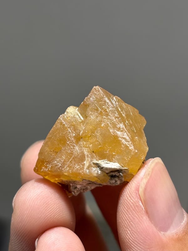 Orange scheelite floater crystal from Xuebaoding, Sichuan, China, view 4 of 5