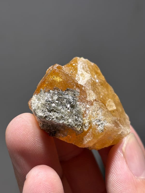 Orange scheelite with grey mica patch from Xuebaoding, Sichuan, China
