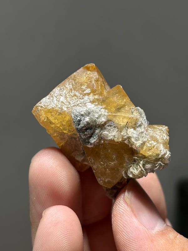 Orange scheelite crystals with white mica from Xuebaoding, Sichuan, China, view 2 of 7
