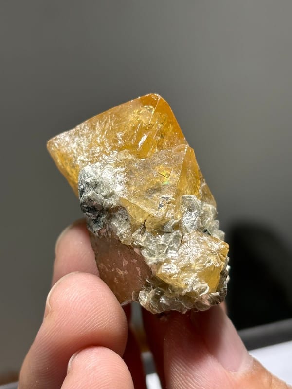 Orange scheelite crystals with white mica from Xuebaoding, Sichuan, China, view 4 of 7