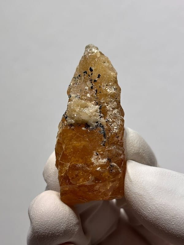 Orange scheelite floater from Xuebaoding, Sichuan, China, view 2 of 5