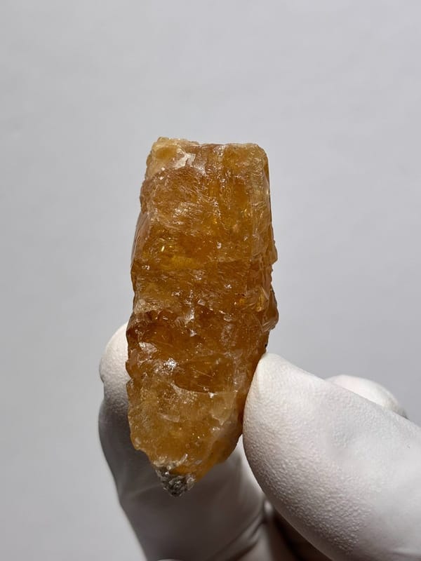 Orange scheelite floater from Xuebaoding, Sichuan, China, view 3 of 5